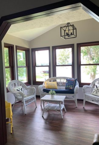 a four season porch on the property with wicker seating set for four