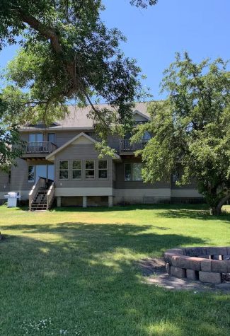 Backyard shot looing at the house with the firepit in view