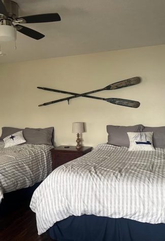 two side by side double beds in one of the bedrooms with a nautical theme