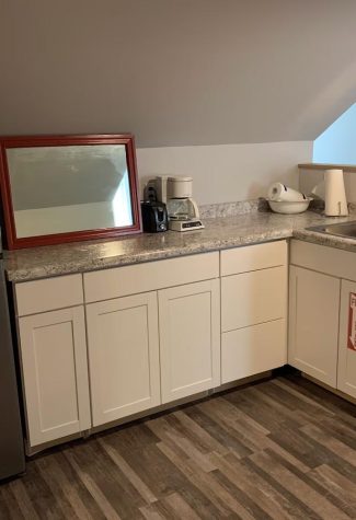Small extra kitchenette area in the upper level with a sink and fridge